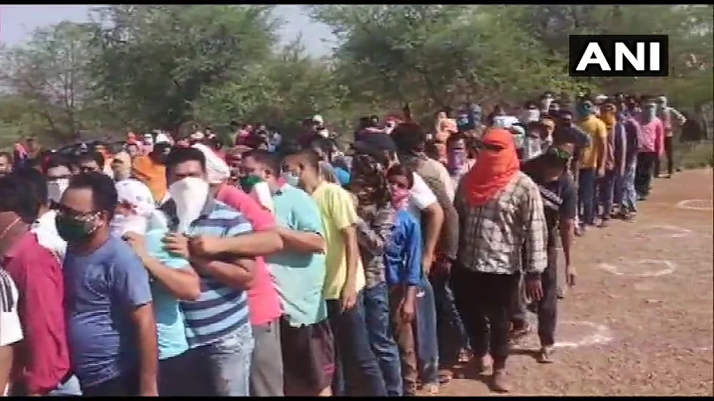 Social distancing norms being flouted as people in large numbers queue outside a liquor shop in Rajnandgaon. T