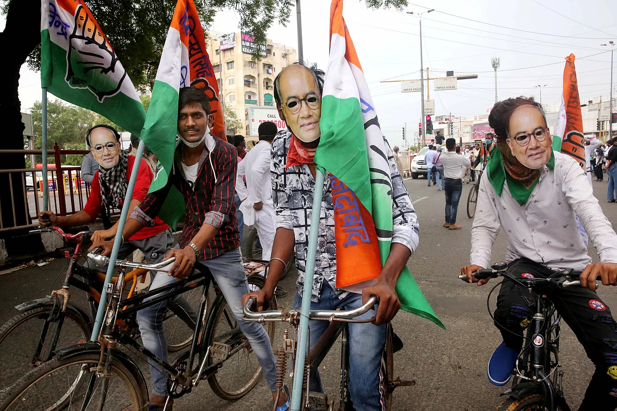 Congress supporters wear face cover of Digvijay Singh as the take part in a protest rally against the continuous price hike of petrol and diesel in Bhopal on Wednesday.