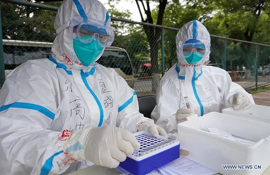 Medical workers collect samples for nucleic acid tests at a sampling site in Fengtai District of Beijing, capital of China, June 15, 2020. Beijing on Sunday conducted nucleic acid tests on 76,499 people, with 59 testing positive for COVID-19, according to a press conference held Monday. As of 6 a.m. Monday, 193 sampling sites had been set up across Beijing to facilitate nucleic acid testings, said Gao Xiaojun, spokesperson for the municipal health commission.