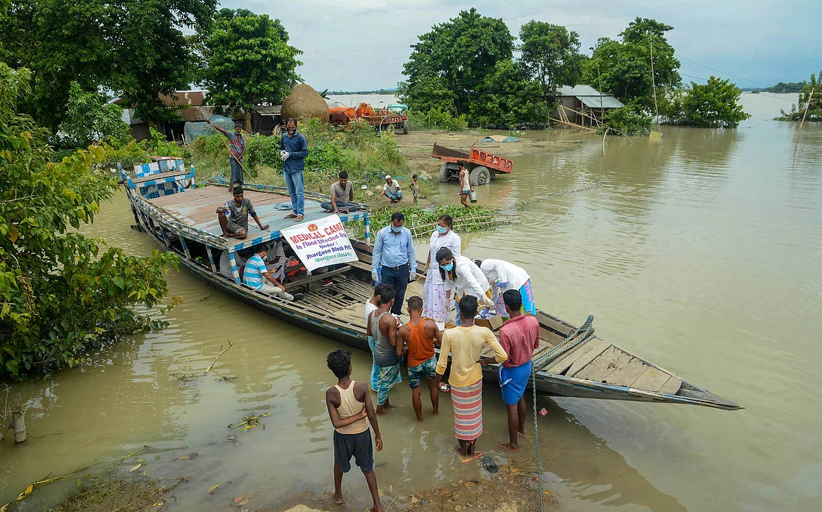 A team of medics provide medicines to the flood-affected people in Morigaon district of Assam, Thursday, July 23, 2020