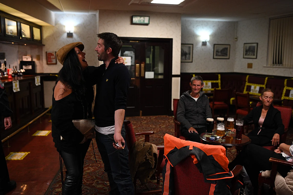 People enjoy a drink inside the Burnley Miners Working Mens Social Club in Burnley, northwest England, on July 4, 2020, as restrictions are further eased during the novel coronavirus COVID-19 pandemic.