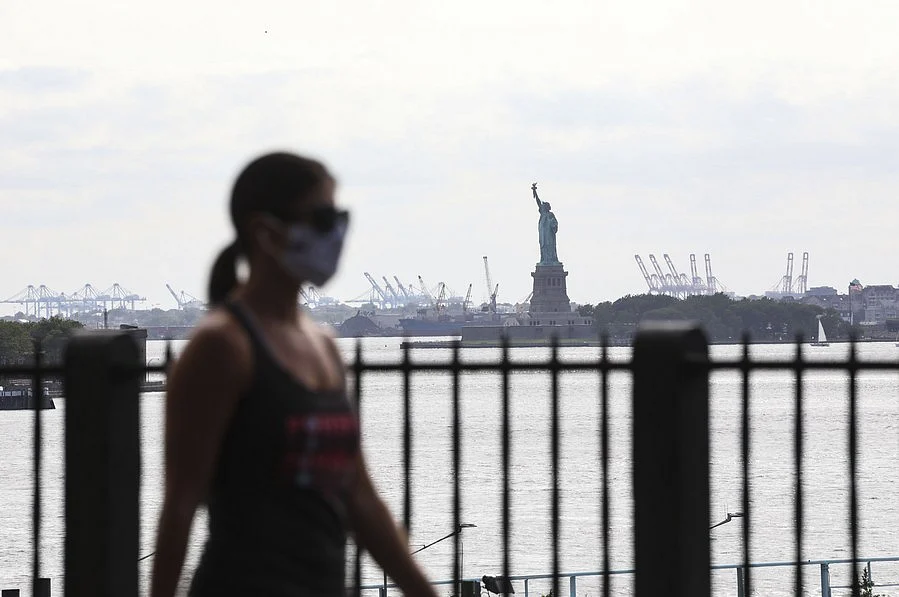 A woman walks in a park in Brooklyn Borough of New York, the United States, on July 16, 2020