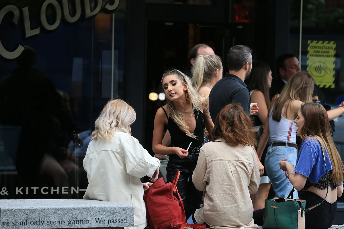 People queue to enter a pub in Newcastle, northern England on July 4, 2020, as restrictions are further eased during the novel coronavirus COVID-19 pandemic