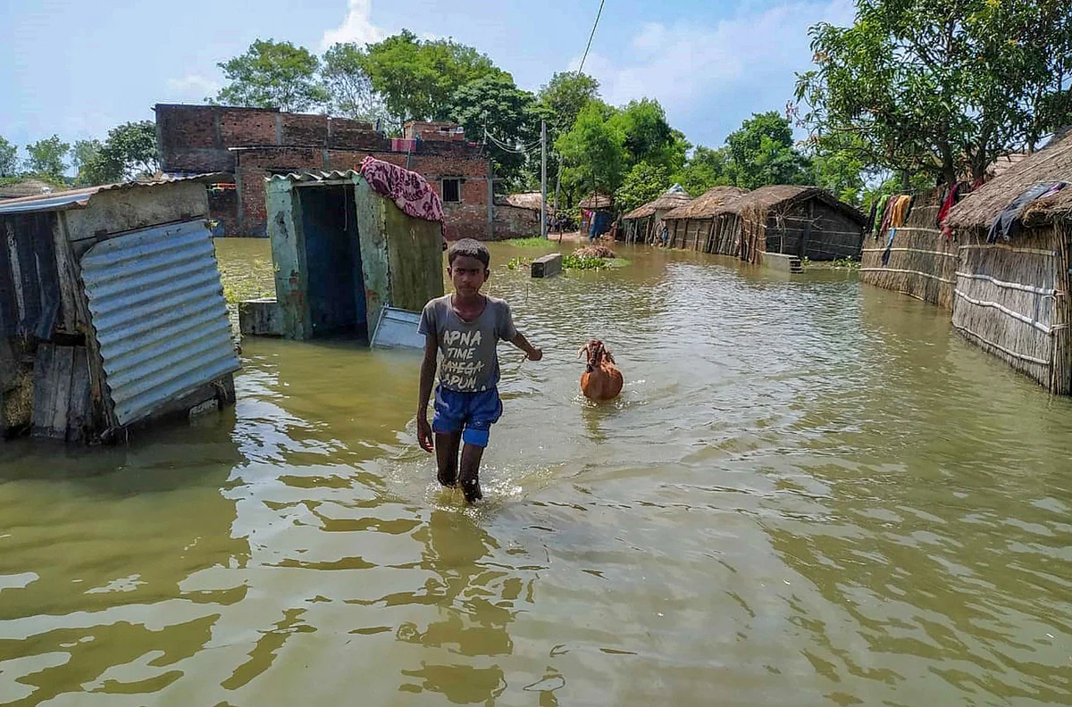 A boy with his goat wades through the floodwater as he moves to a safer place, in Bihar's Gopalganj district, Thursday, July 23, 2020.
