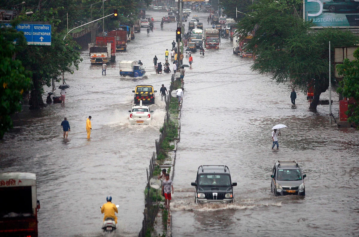 Vehicles ply through water logged LBS roads after heavy rainfall, in Mumbai on Sunday.