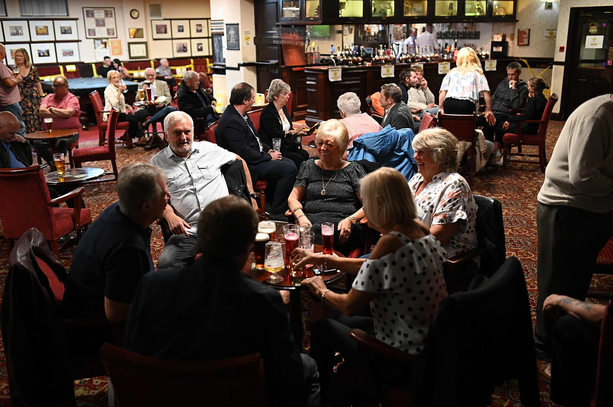 People enjoy a drink inside the Burnley Miners Working Mens Social Club in Burnley, northwest England, on July 4, 2020, as restrictions are further eased during the novel coronavirus COVID-19 pandemic.