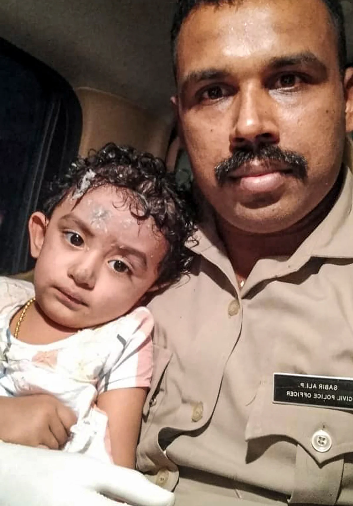 A child rescued after an Air India Express flight with passengers on board en route from Dubai skidded off the runway while landing, at Karippur in Kozhikode, Friday, Aug. 7, 2020.