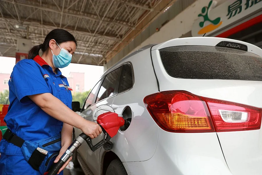 A staff member refuels a car at a gas station in Xingtai, north China's Hebei Province, June 28, 2020