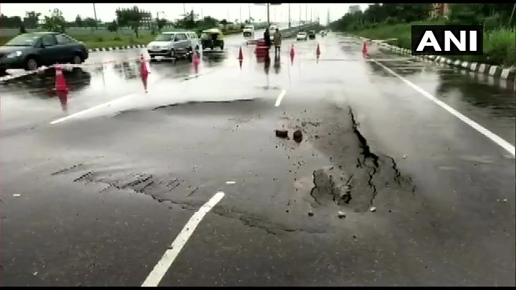 portion of road caves in near Gurugram's IFFCO Chowk, following heavy rainfall in the region.