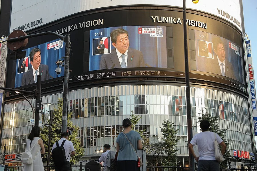 Electronic screens show that Japanese Prime Minister Shinzo Abe speaks at a press conference in Tokyo, Japan, on Aug. 28, 2020