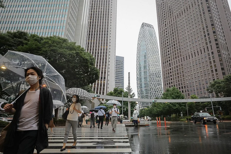 People wearing face masks walk on the street in Shinjuku, Tokyo, Japan, on July 9, 2020.