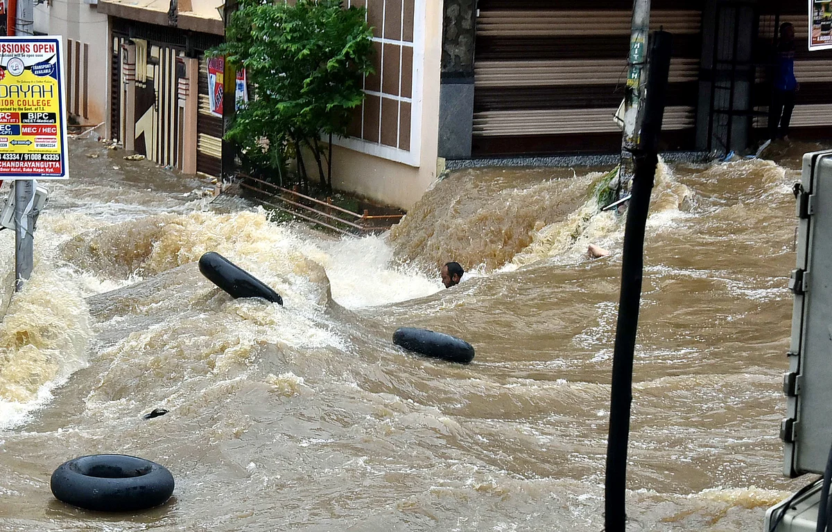 Watch: Man swept away, cars damaged as torrential rain batters Hyderabad