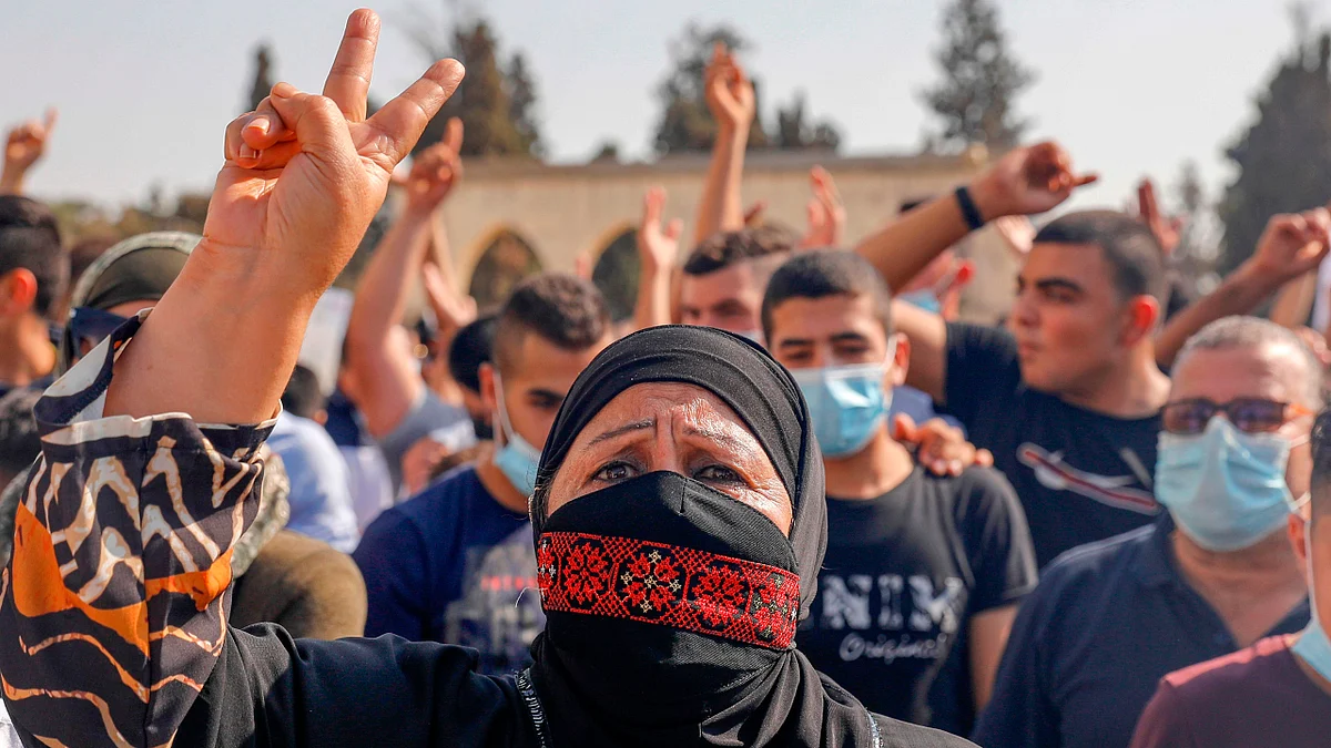 Palestinians shout slogans as they gather to protest against the French President, in the al-Aqsa mosque compound, in the Old City of Jerusalem