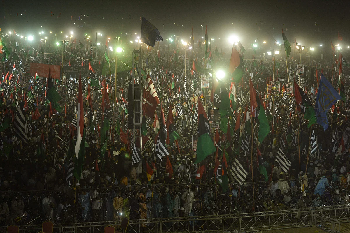 Activists of the newly-formed Pakistan Democratic Movement (PDM), an opposition alliance of 11 parties, raise their hands during the public rally in Karachi on October 18, 2020.