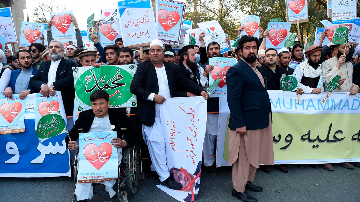 Muslim demonstrators hold banners as they shout slogans during a protest in downtown Kabul