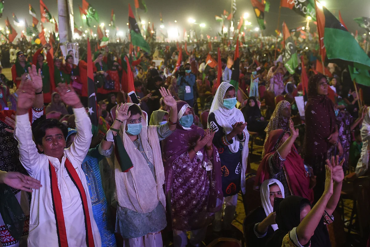 Activists of the newly-formed Pakistan Democratic Movement (PDM), an opposition alliance of 11 parties, raise their hands during the public rally in Karachi on October 18, 2020.