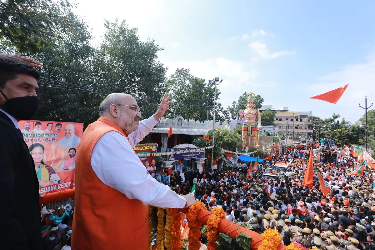 Union Home Minister Amit Shah waves to his supporters during his roadshow in Hyderabad.