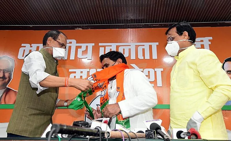 Congress MLAs Narayan Patel joins BJP in presence of Madhya Pradesh Chief Minister Shivraj Singh Chouhan and party State President VD Sharma at partys State headquarters in Bhopal on July 23.