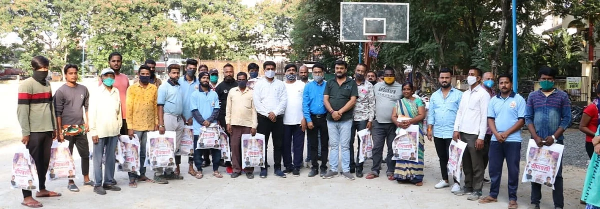 A group photo of sanitation workers with group members