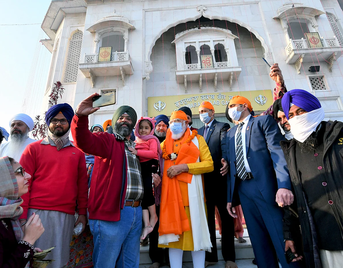 People click a selfie with Prime Minister Narendra Modi as he visits Gurudwara Rakab Ganj Sahib on the occasion of the 400th Prakash Parv of Guru Teg Bahadur, in New Delhi on Sunday.