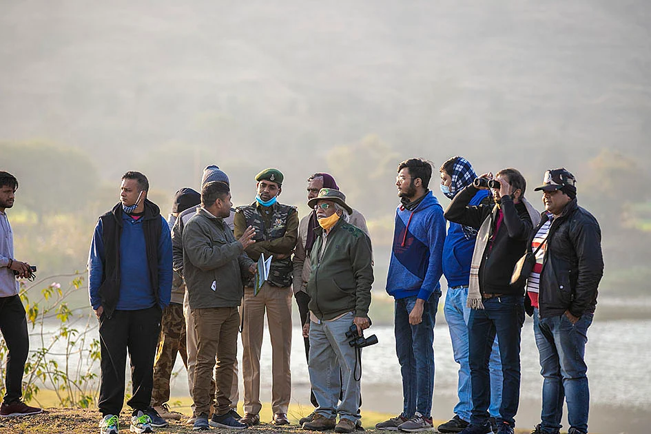 Painter, sculptor, writer, photographer and environmentalist Padmashri Bhalchandra Dattatray Mondhe at Remand talab with other photographers and nature lovers in Dhar
