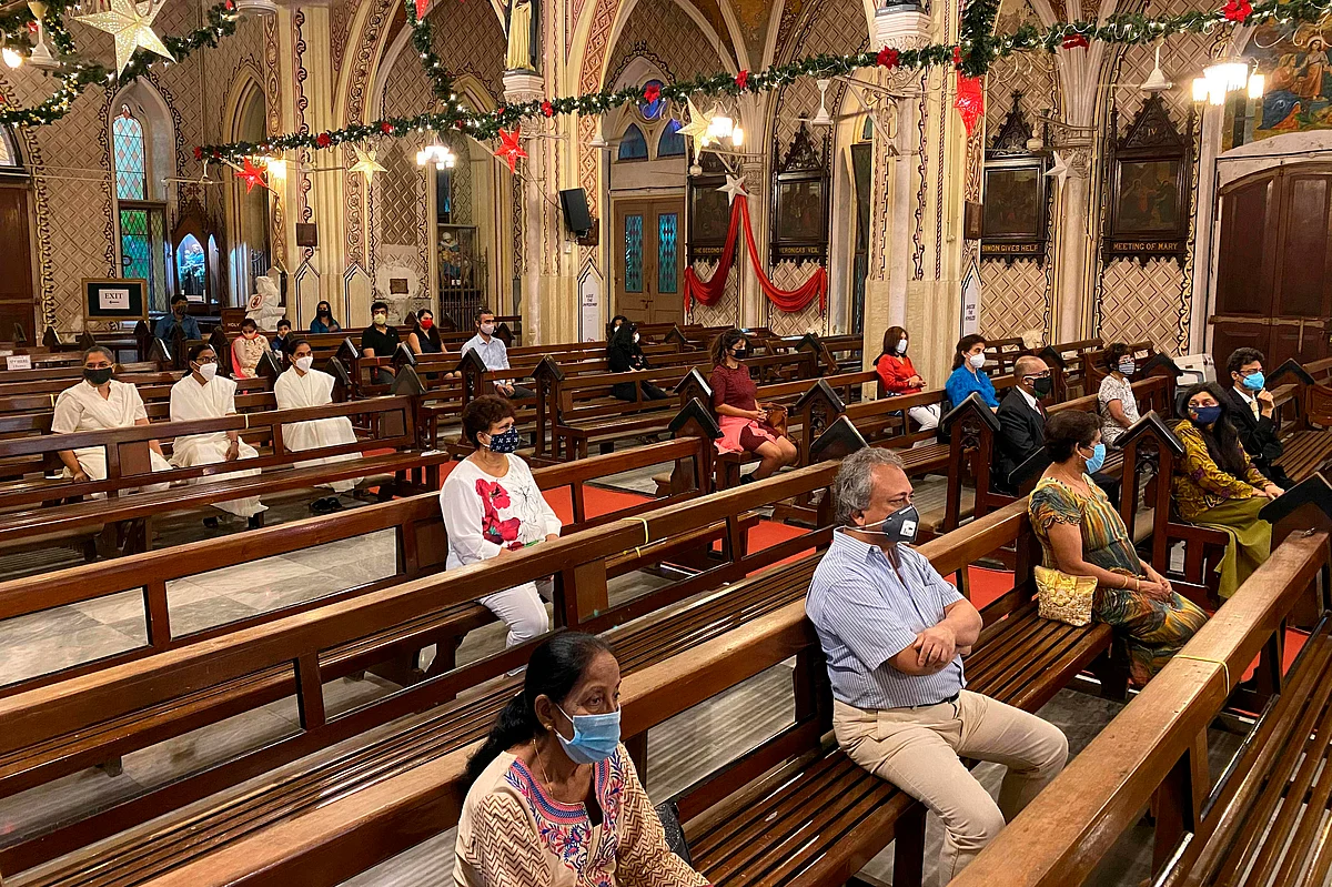 Christian devotees take part in a mass service on the eve of Christmas, in Mumbai on December 24, 2020