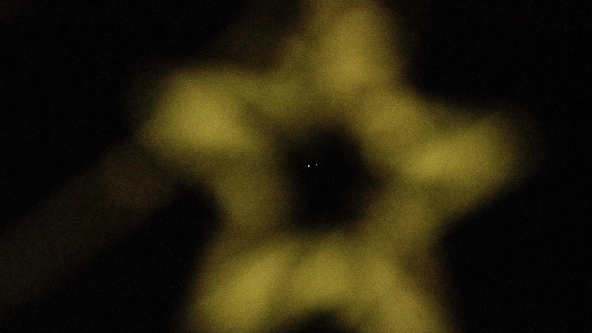 A great conjunction of the planets Jupiter (L) and Saturn which comes after nearly 400 years is seen behind Christmas decorations in the night sky above Koh Lipe island on December 21, 2020.