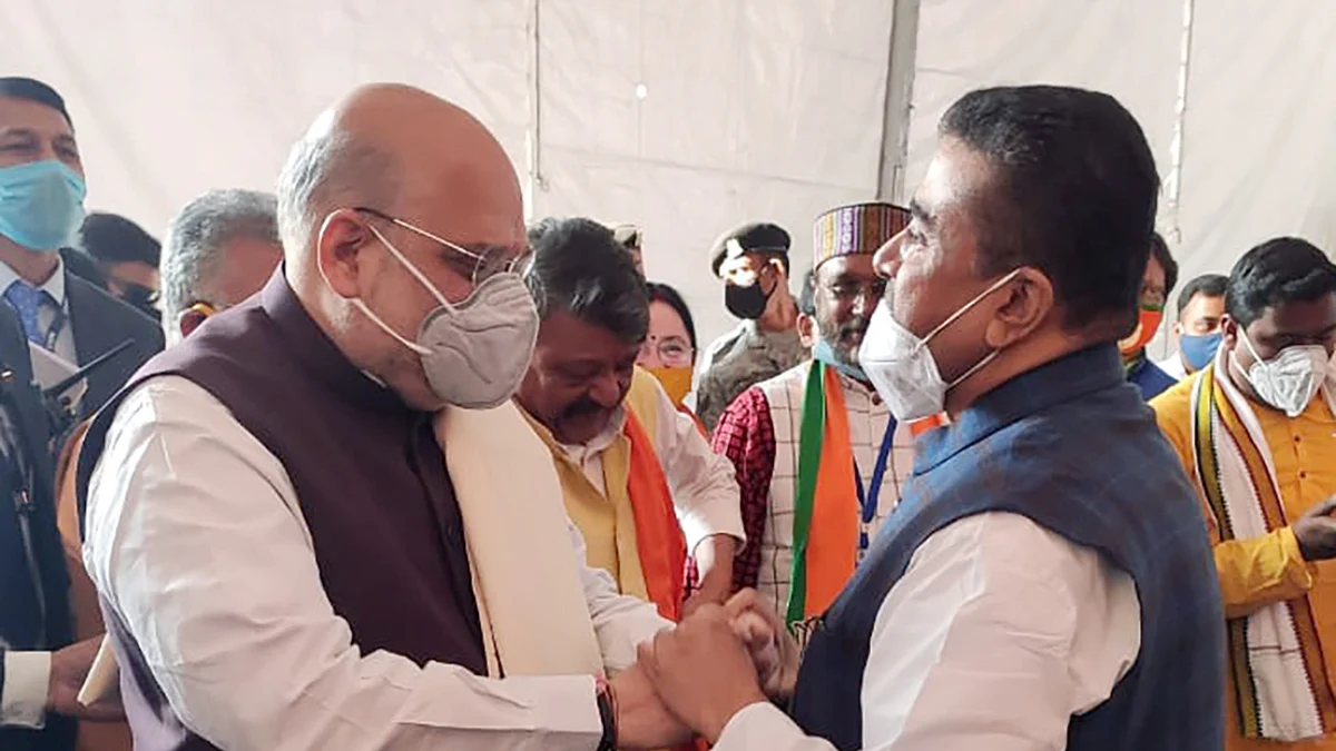 Home Minister Amit Shah interacts with Suvendu Adhikari during a public rally, at Midnapore College Ground, in Midnapore on Saturday.