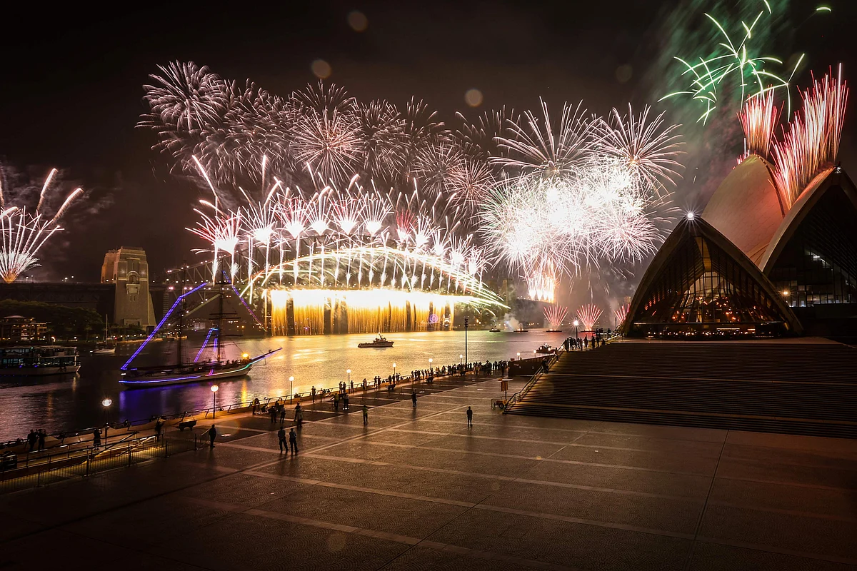 A deserted Sydney Opera House forecourt can be seen in front of fireworks exploding from the Sydney Harbour Bridge during New Year celebrations in central Sydney on January 1, 2021.