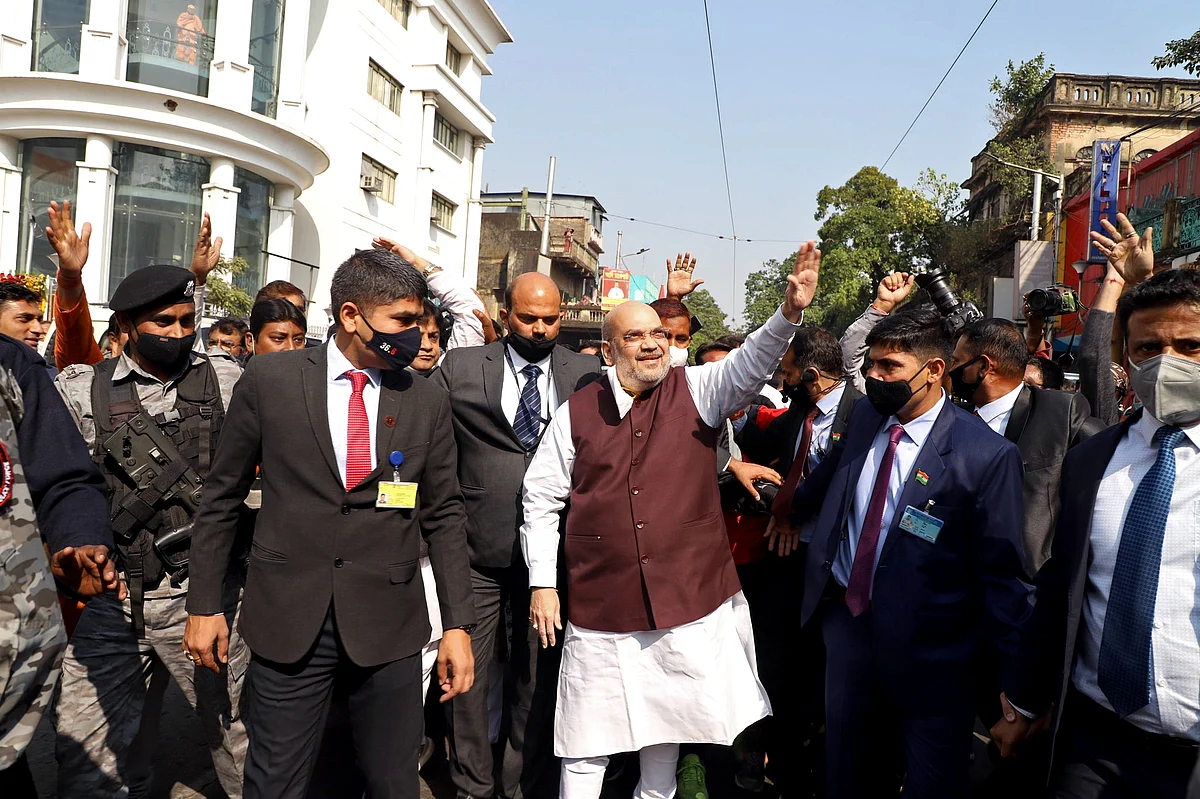 Union Home Minister Amit Shah waves to supporters during his visit to Swami Vivekanand ancestral house at Ramakrishna Ashram in Kolkata on Saturday.