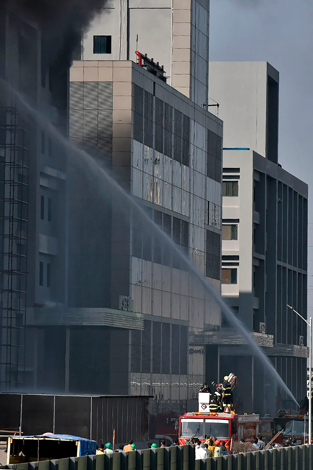 Firefighters try to control a fire that broke out at Indias Serum Institute in Pune on January 21, 2021. - A fire broke out on January 21 at Indias Serum Institute, the worlds largest maker of vaccines, local TV footage showed, but media reports said production of the Covid-19 coronavirus vaccine was not affected.