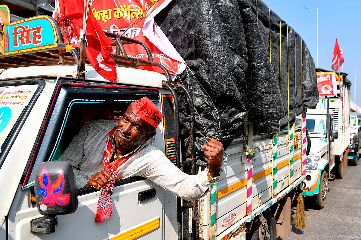 A farmer shouts slogans inside a vehicle as he crosses along with others a state highway during a rally to Mumbai in support of farmers who are continuing their protest against the central governments recent agricultural reforms, at Bhiwandi in the Thane district of Maharashtra on January 24, 2021.