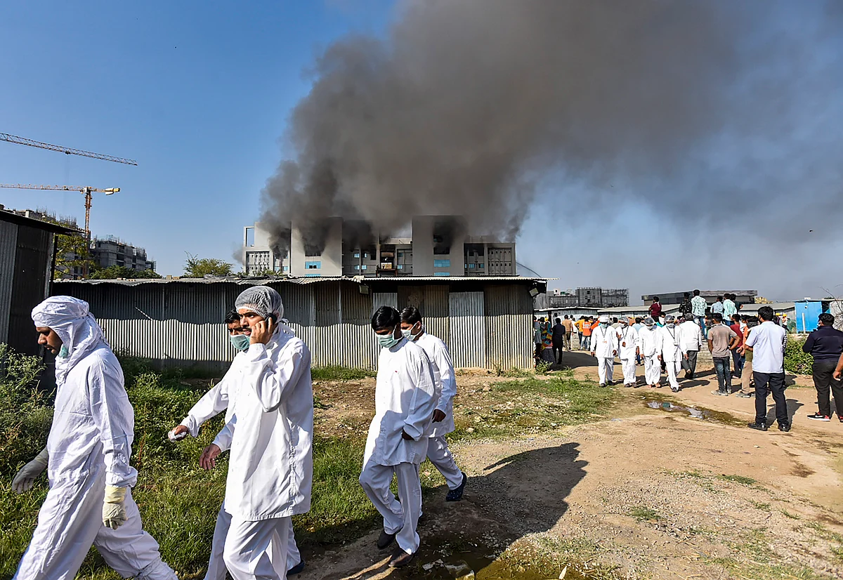 Pune: Workers of Serum Institute of India come out of the building after fire broke out in it, in Pune, Thursday, Jan. 21, 2021