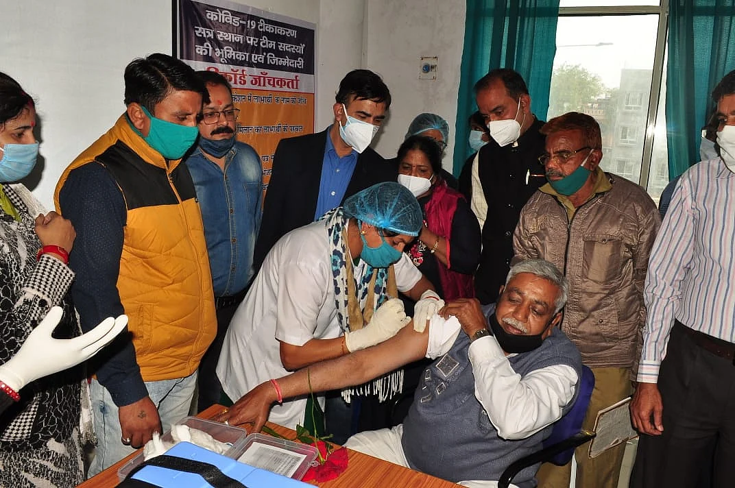 Sanitary worker Kailash received first vaccine in Ujjain in presence higher education minister Dr Mohan Yadav, MP Anil Firozia, others
