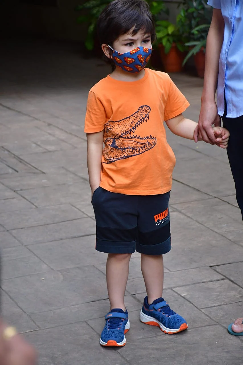 Watch: Taimur Ali Khan enjoys father Saif's 'Ole Ole' song as he feeds cow outside their Bandra residence