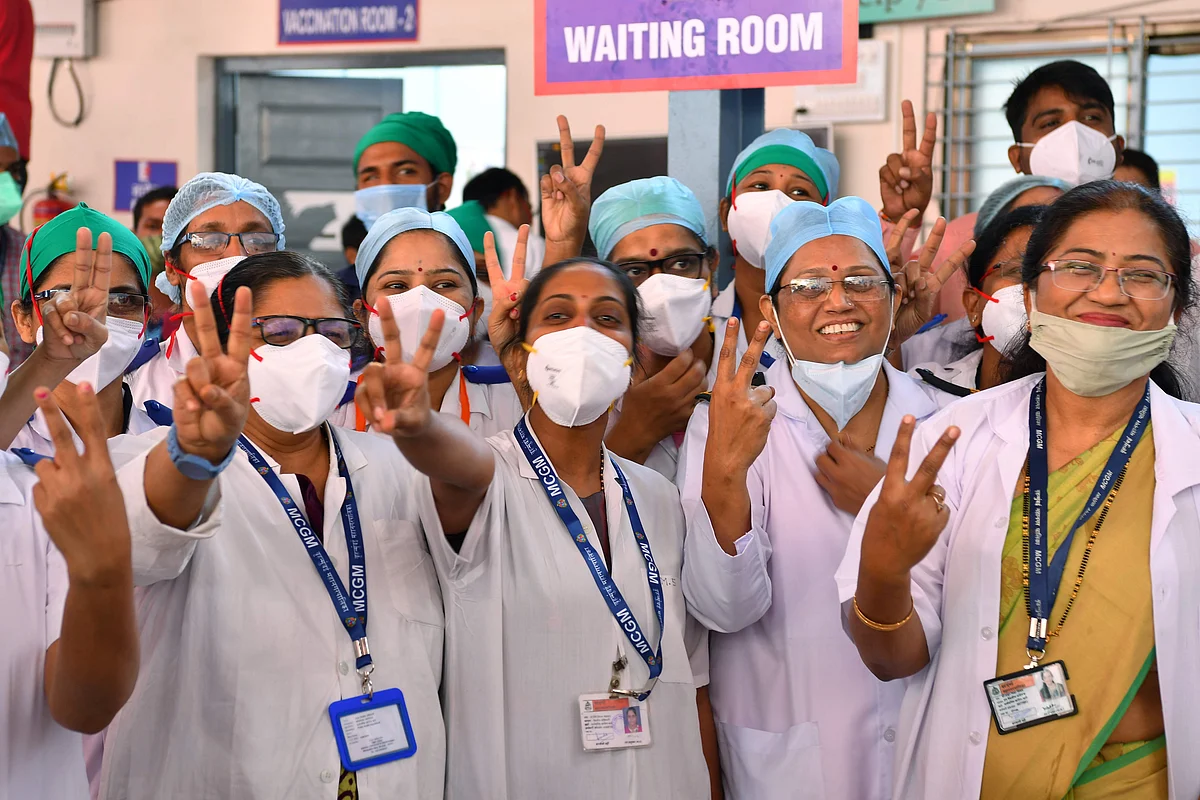 Doctors of the Rajawadi Hospital make the victory sign as they wait for the start of the Covid-19 coronavirus vaccination drive in Mumbai on January 16, 2021.