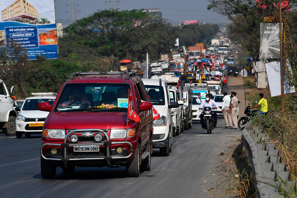 Farmers in vehicles cross a state highway during a rally to Mumbai in support of the ongoing farmers protest against the central governments recent agricultural reformson, at Bhiwandi in the Thane district of Maharashtra on January 24, 2021.