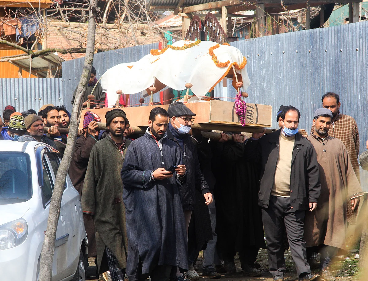 Muslims carry the body of Kashmiri pandit woman in Kunzer Village of Jammu and Kashmir.