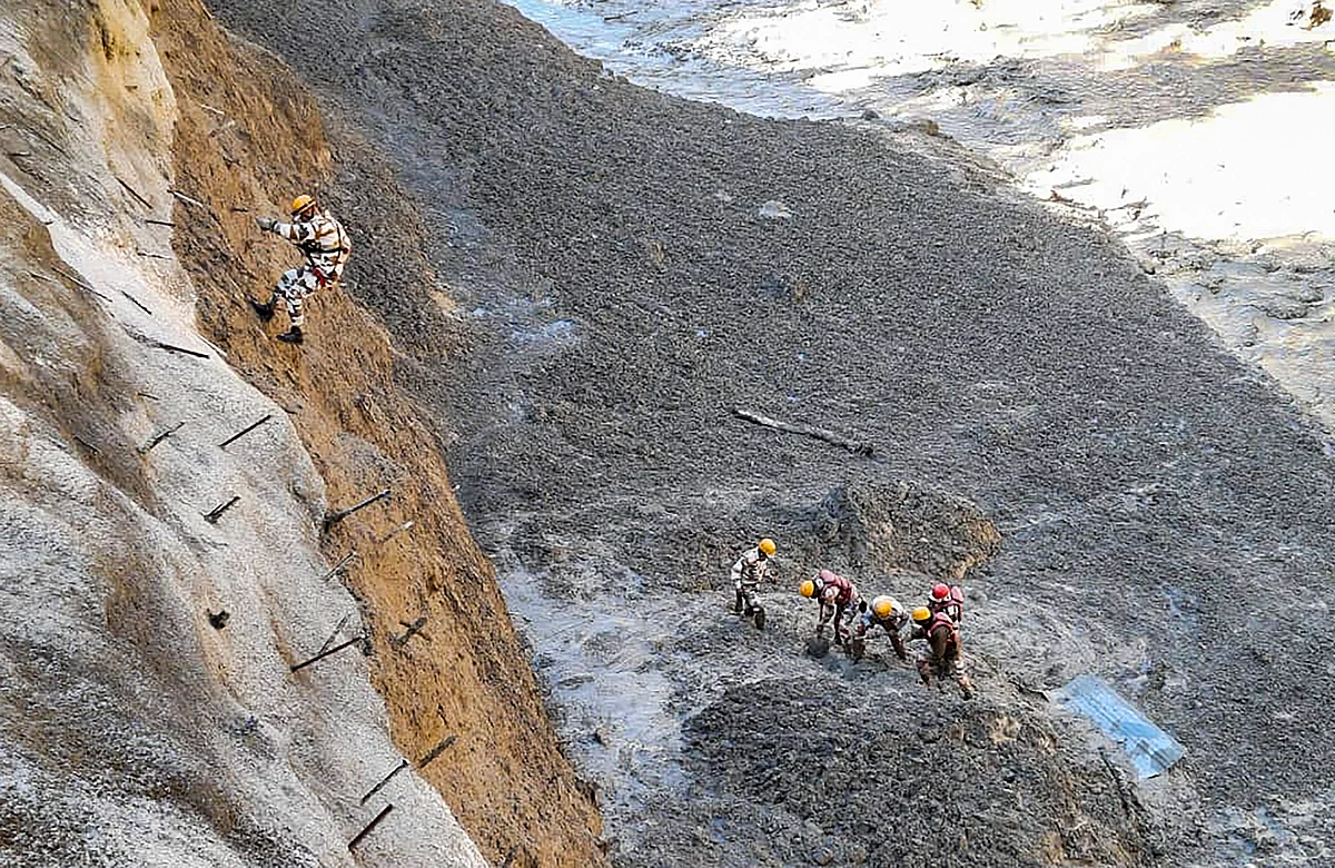 ITBP personnel dig to open Tapovan Tunnel which is completely blocked, after a glacier broke off in Joshimath in Uttarakhand?s Chamoli district causing a massive flood in the Dhauli Ganga river, Sunday, Feb. 7, 2021.