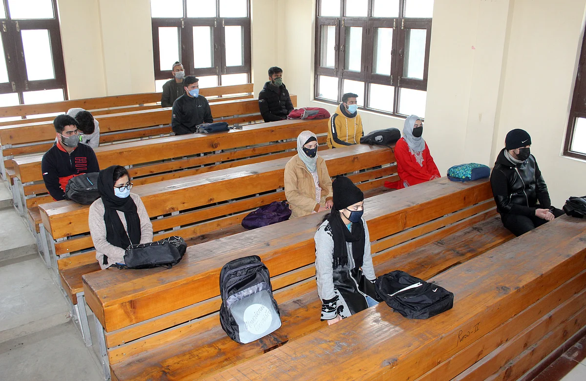 Students wearing face masks as a precaution against the coronavirus, attend classes as Colleges reopen after being closed for months due to the COVID-19 pandemic in Srinagar, Kashmir