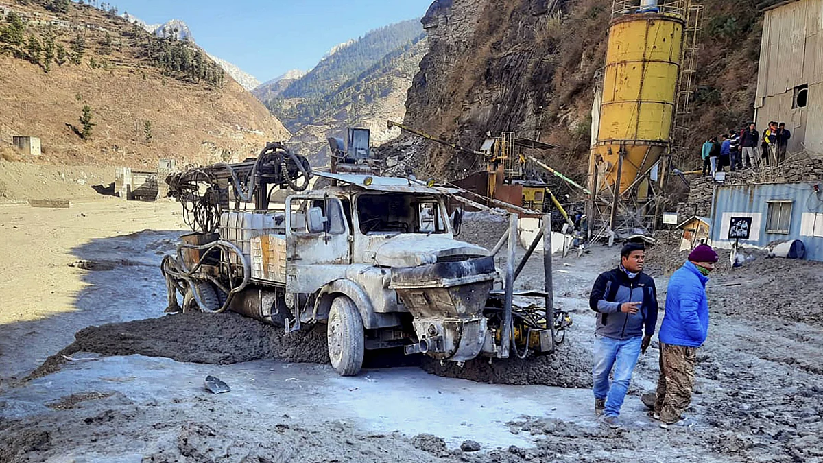 Locals inspect the site near damaged Dhauliganga hydropower project at Reni village, after a glacier broke off in Joshimath causing a massive flood in the Dhauli Ganga river, in Chamoli district of Uttarakhand, Sunday, Feb. 7, 2021.