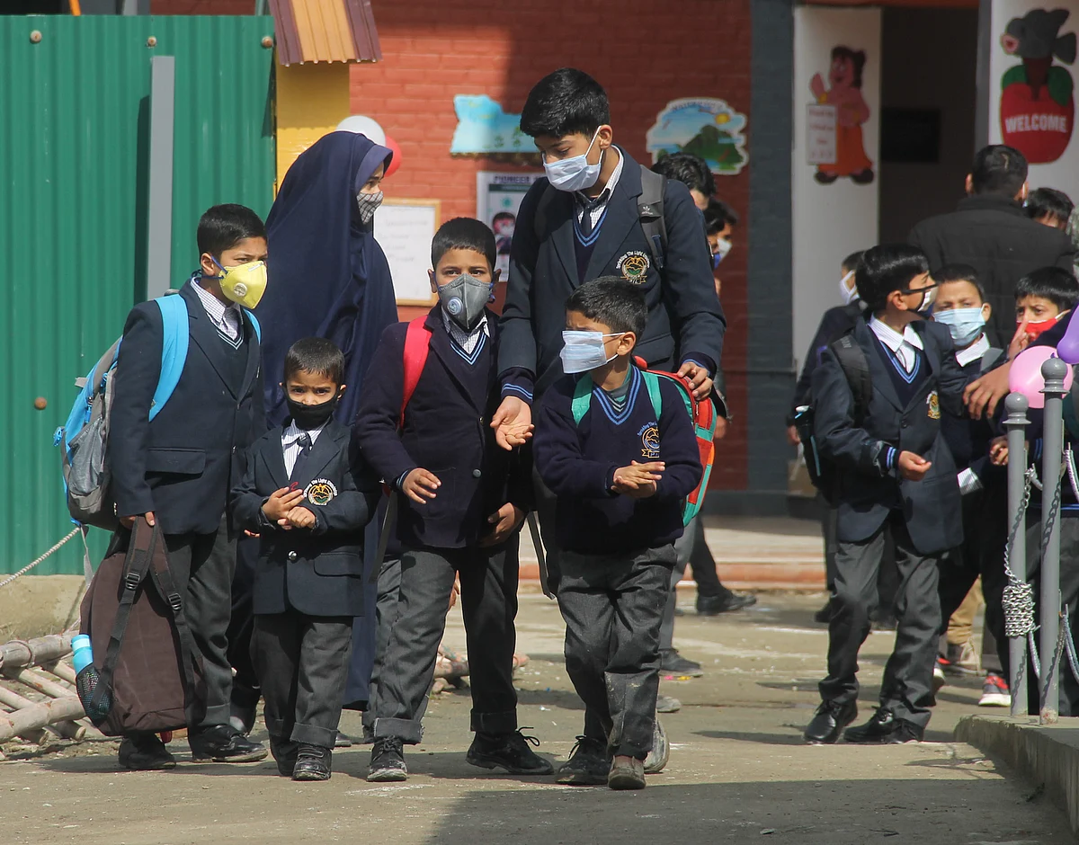 Students of junior wing attending classes on the first day of school as they reopen after almost a year, at Srinagar, kashmir.