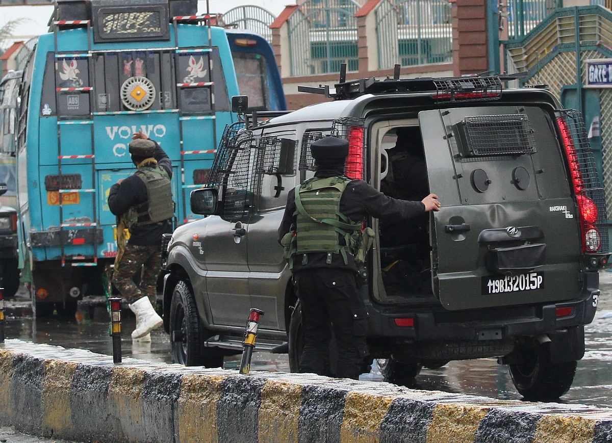 Paramilitary troopers are seen near the site of an attack by suspected militants on Municipal councillor, at Sopore in North Kashmir.