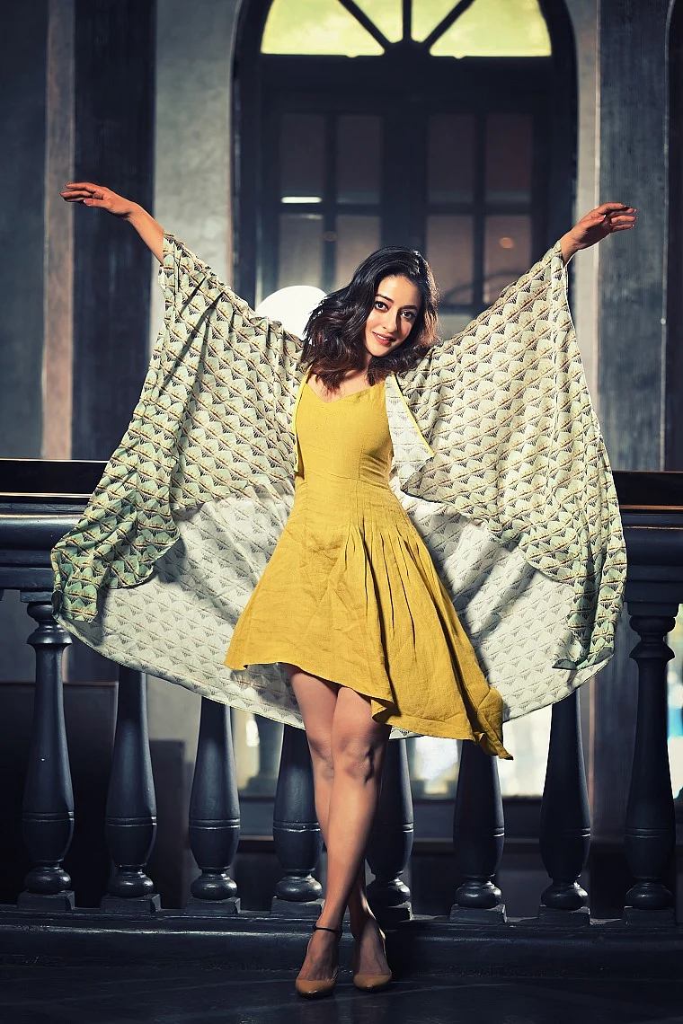 The actor stuns in an asymmetrical canary yellow dress with digital printed kaftan jacket