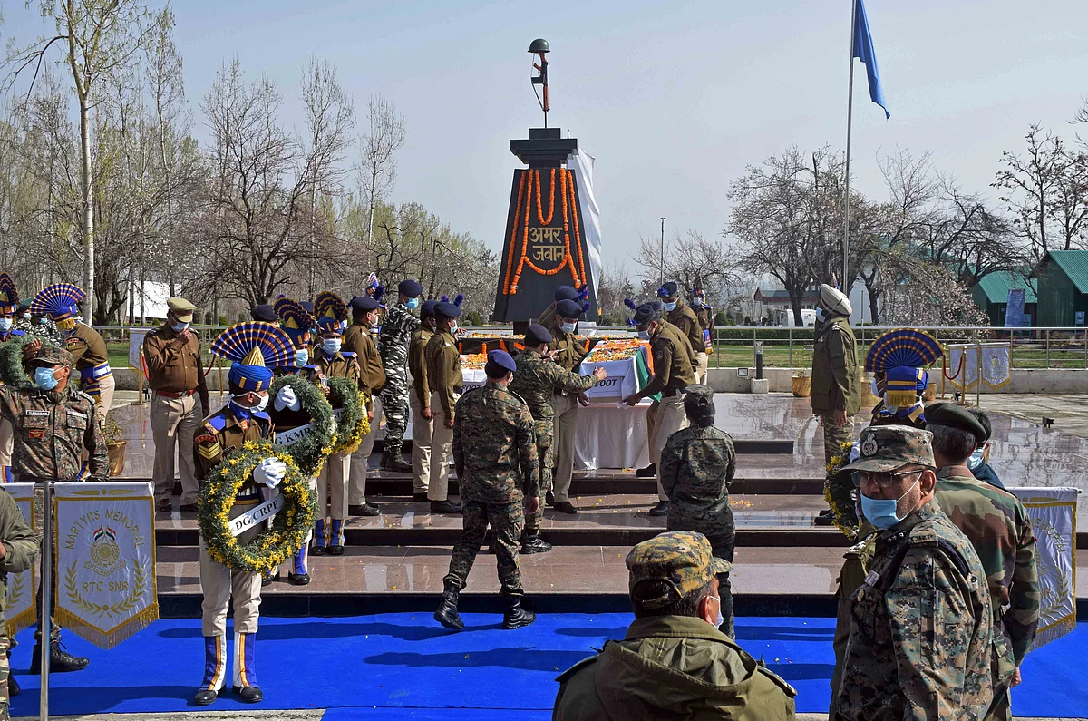 Senior security officers carry the coffins of two CRPF personnel, who were killed in a militant attack at Lawaypora, after wreath laying ceremony at Humahama on the outskirts of Srinagar.