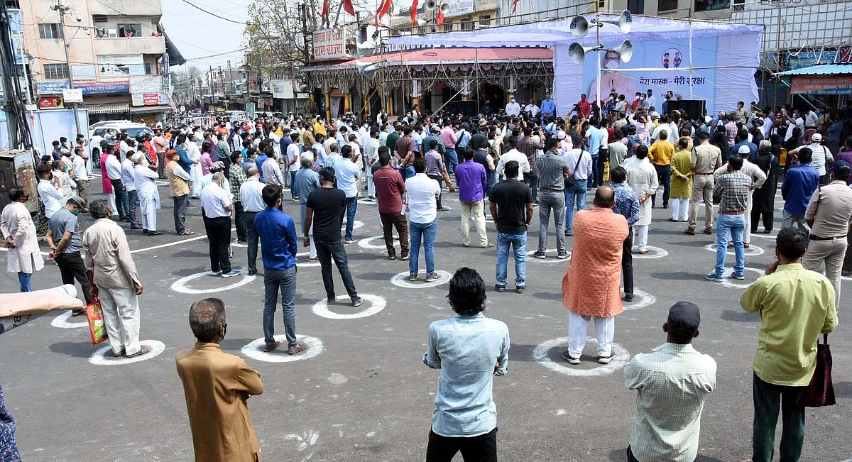 People stand on the road to observe two-minute silence as a state-wide campaign My Mask My Security launched by the State Chief Minister Shivraj Singh Chouhan to maintain COVID-19 safety norms, in Bhopal on Tuesday.