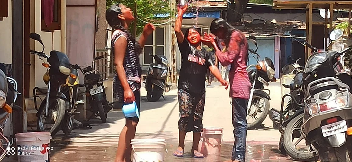 Three friends get wet during Holi play in Ujjain
