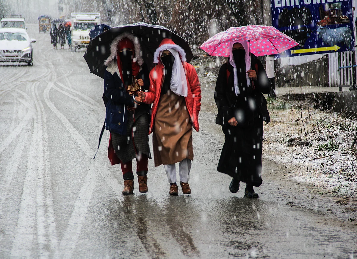 Commuters on the road during fresh snowfall on March 08 2021 in parts of Kashmir.