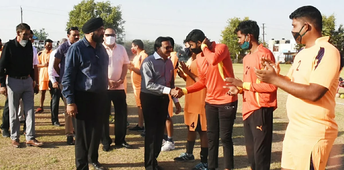 Former minister Sajjan Singh Verma shakes hands with players