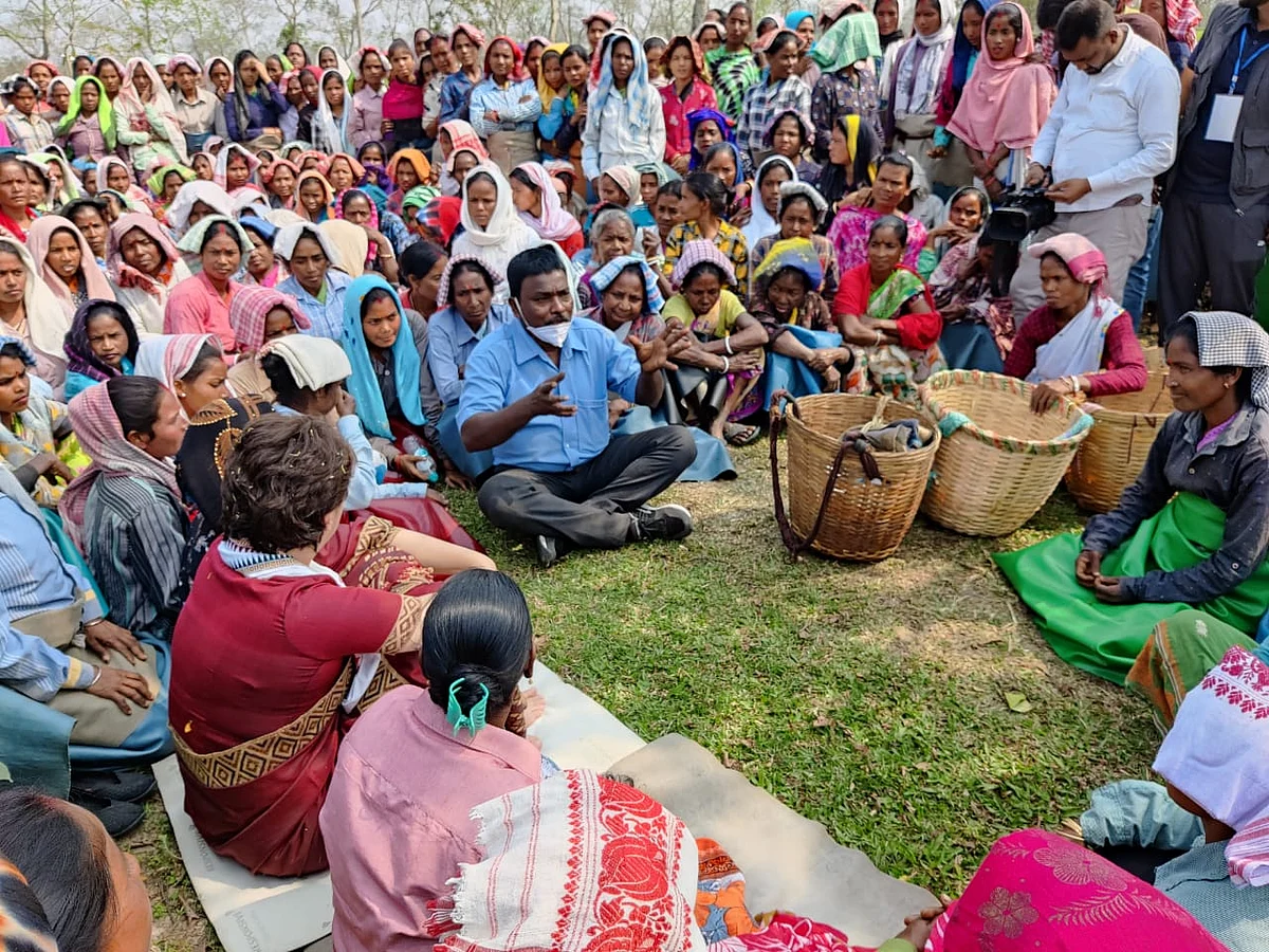 Priyanka Gandhi Vadra sitting with tea garden workers at Sadhuru tea garden, Biswanath, Assam.